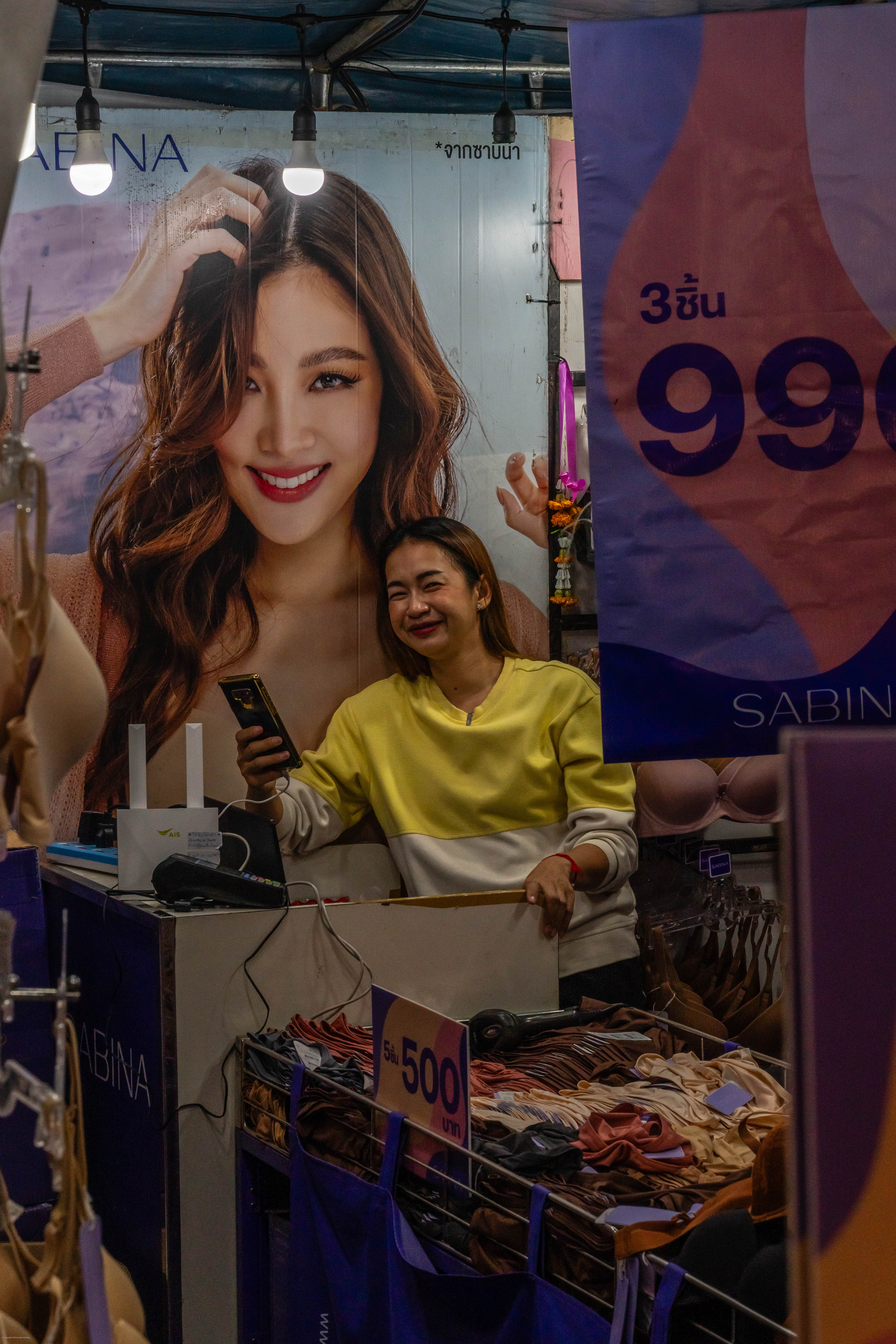 Brassiere saleslady with goods, poster.