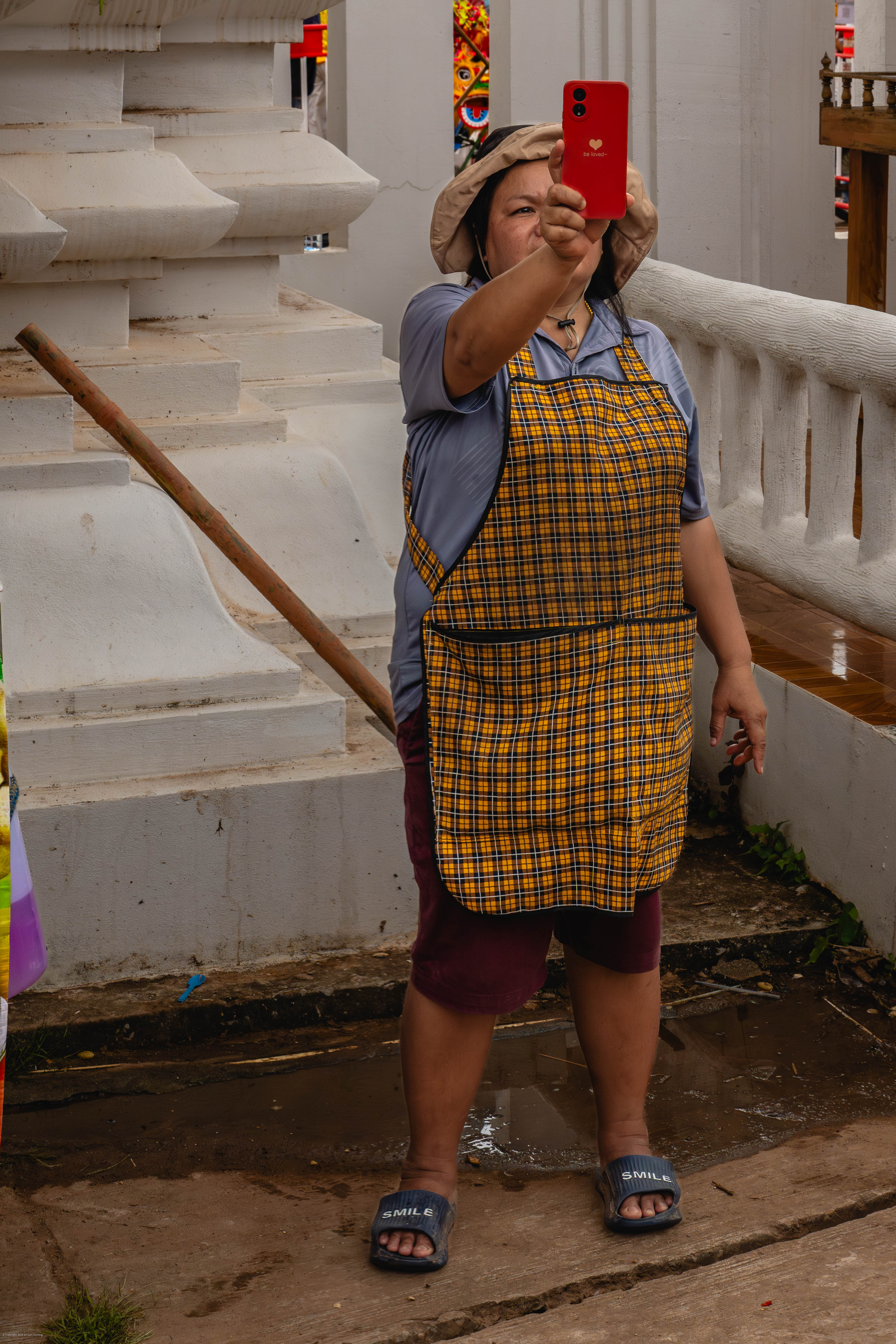 Lady in apron holding up phone