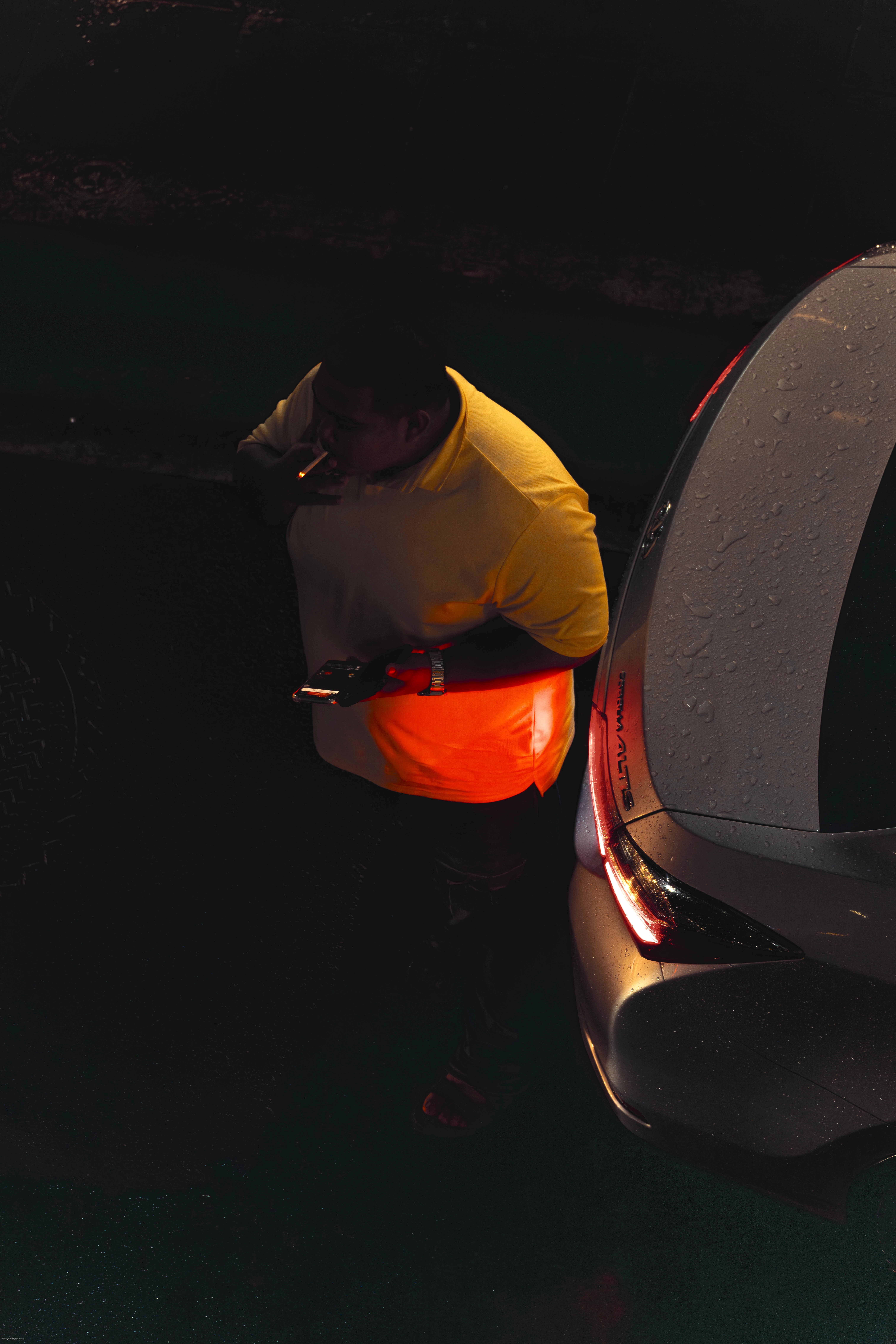 A man lighting a cigarette in the dark.