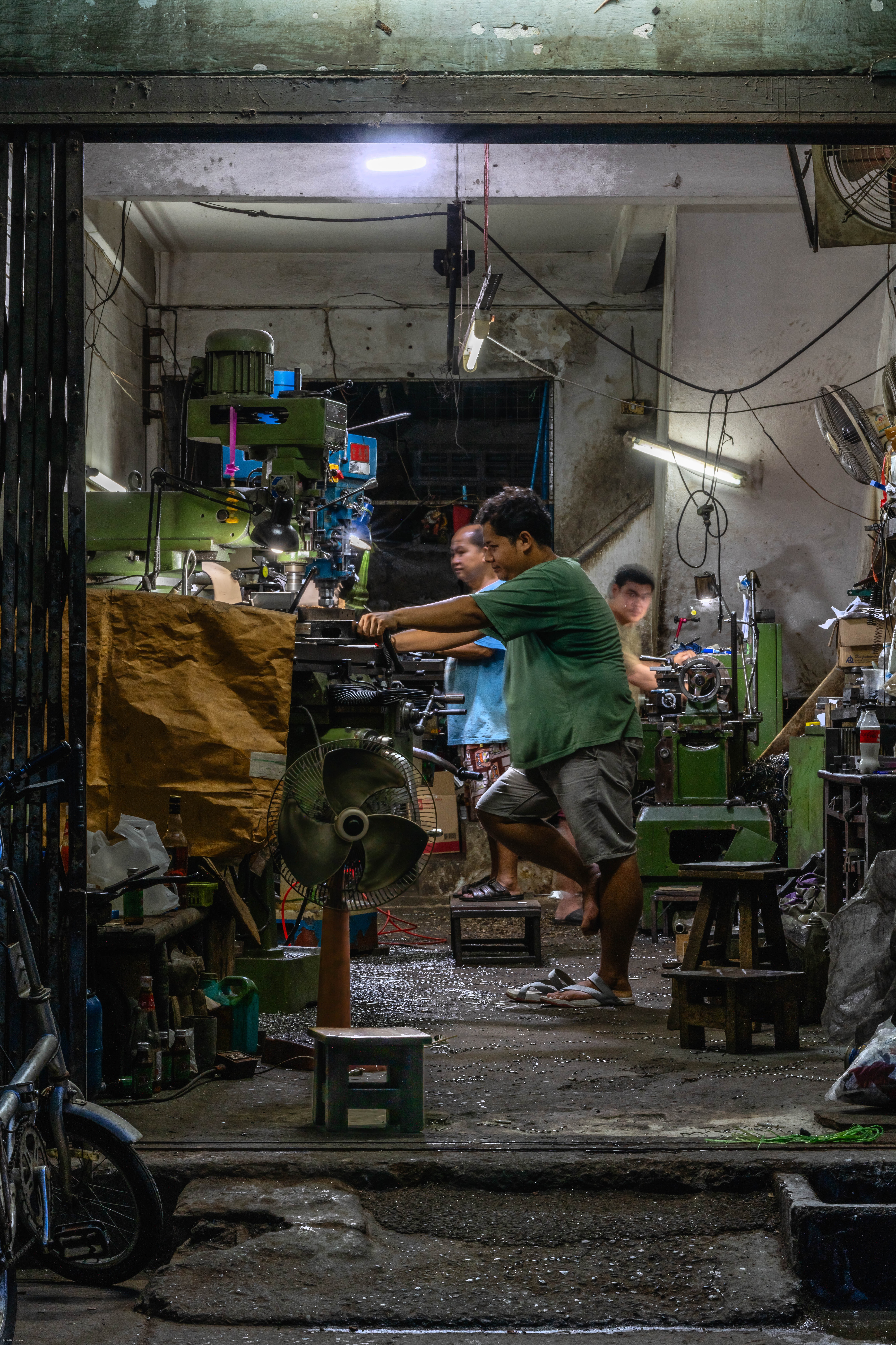 Workers in small machine shop.