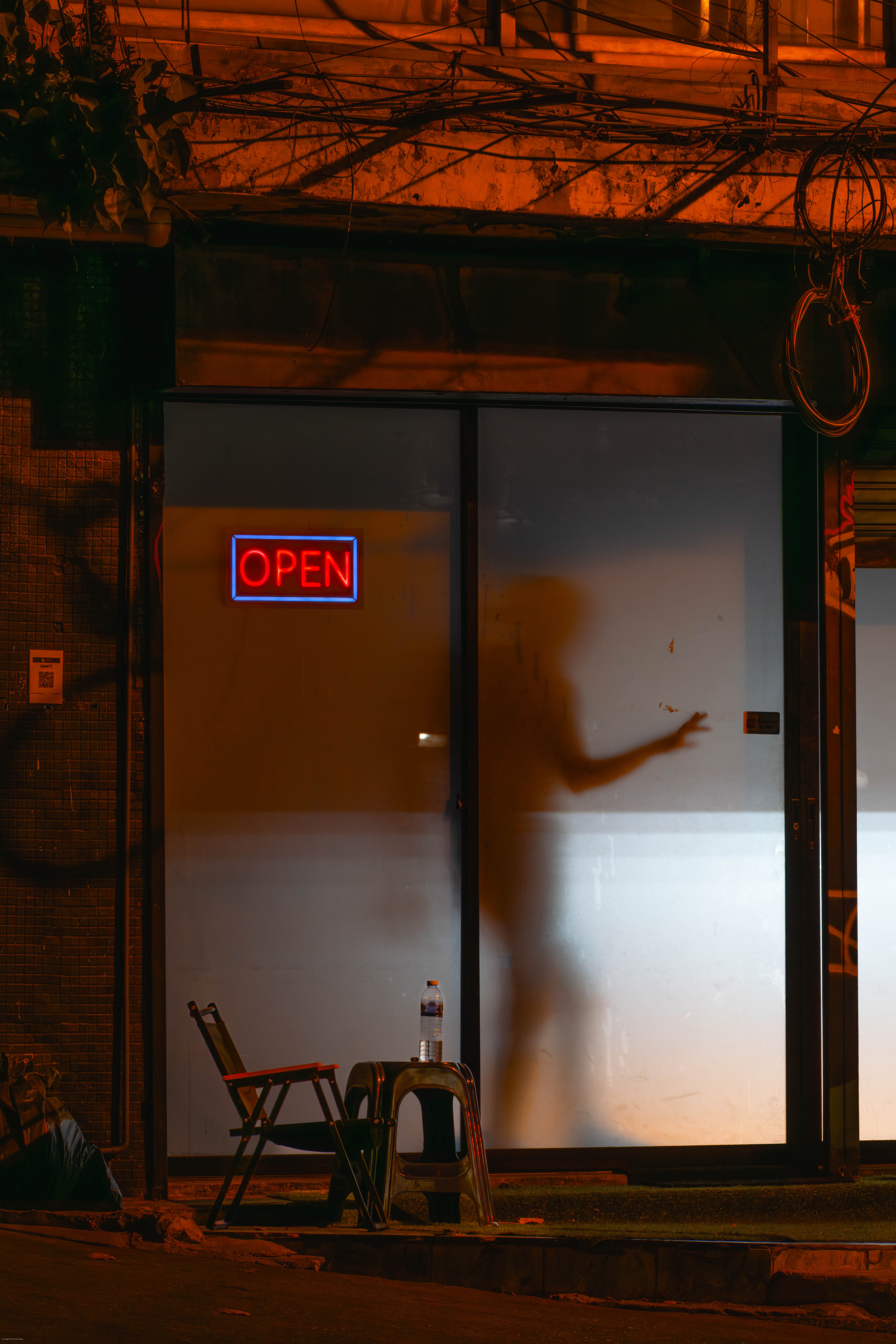 A man in a restaurant casts a shadow.