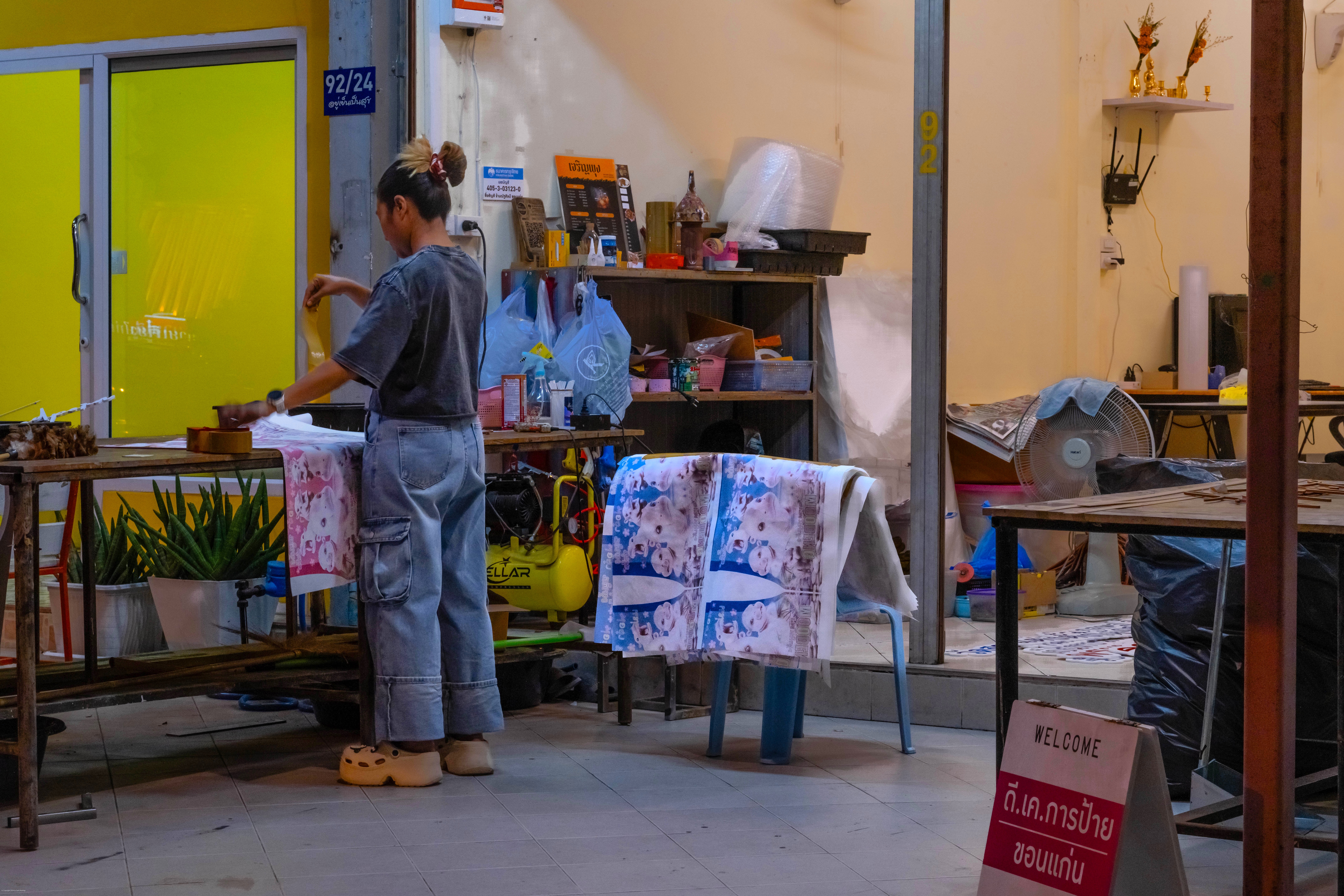 Print shop preparing Moo Deng posters for shipment.