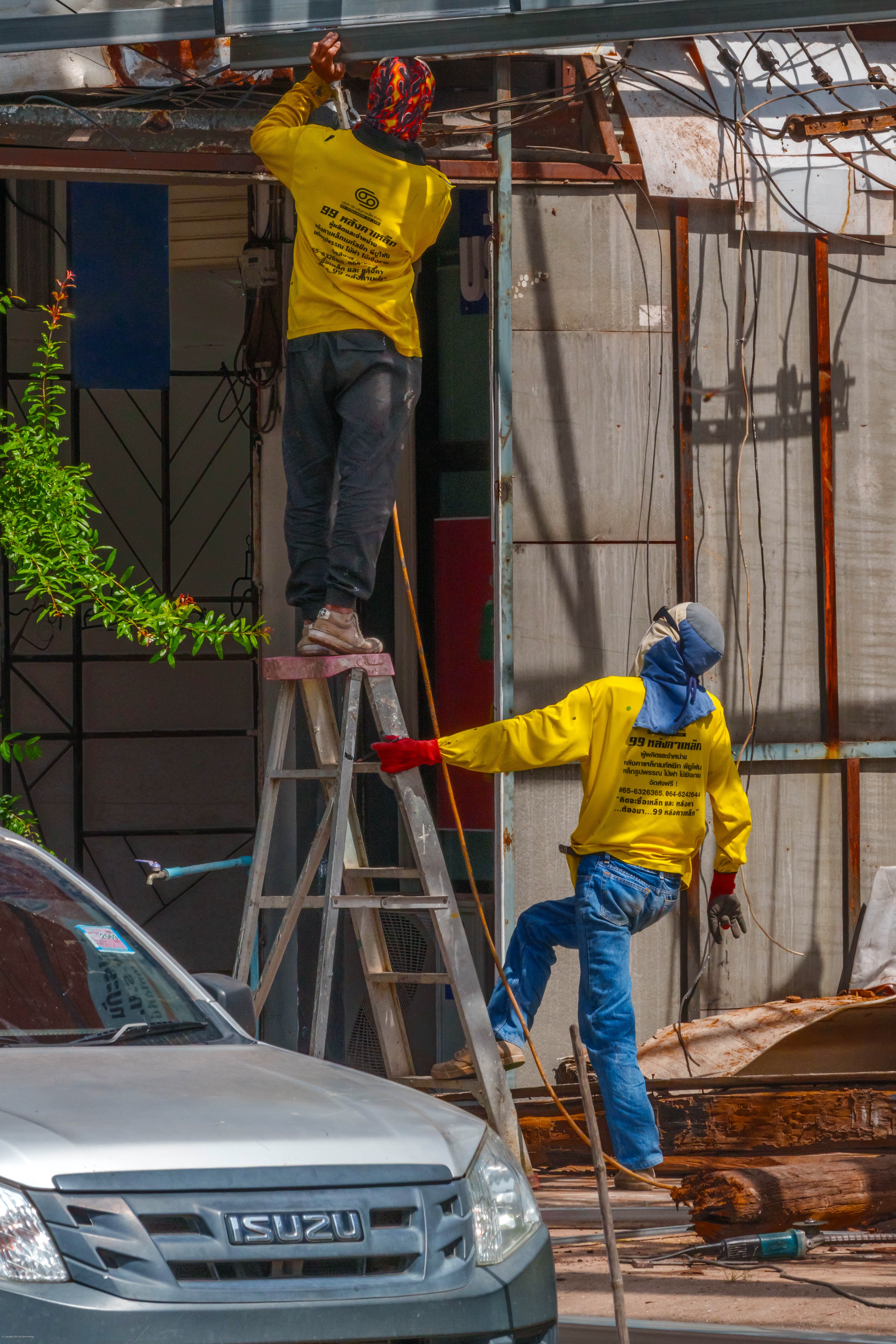 Workers installing a storefront.
